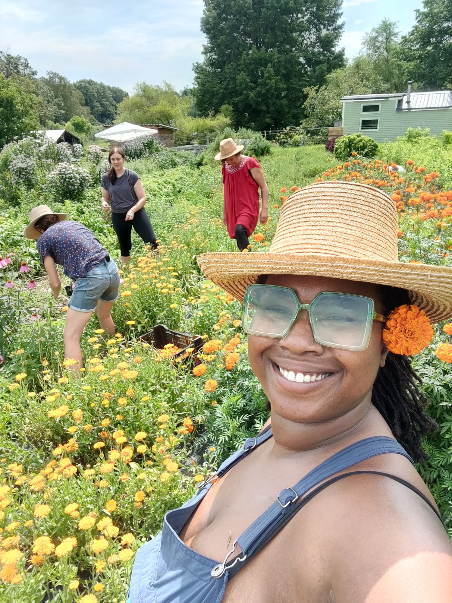 Woman in a garden with flowers and other people in the background